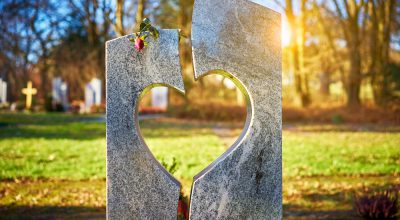 Tombstone with heart on graveyard